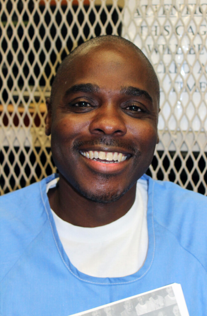 African American man with big smile in prison