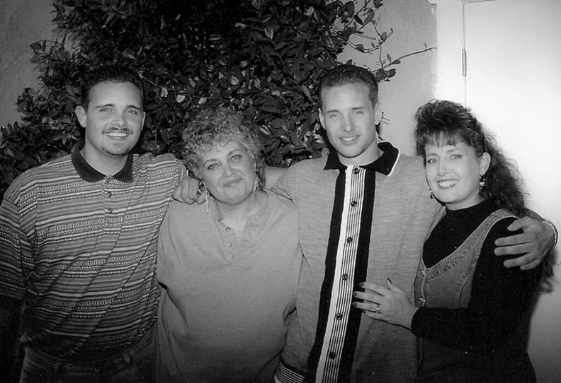 Mother with two sons and daughter smiling in a group