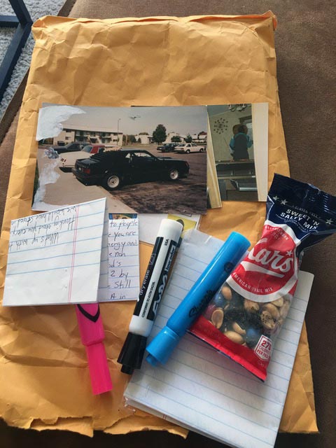 Contents of package - pens, markers, letter, bag of peanute, photo of truck