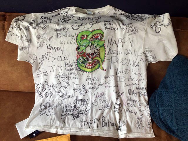 T-shirt with picture of dragon and happy birthday signatures all over it