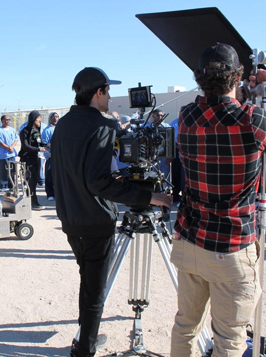 Documentary crew members standing with equipment waiting