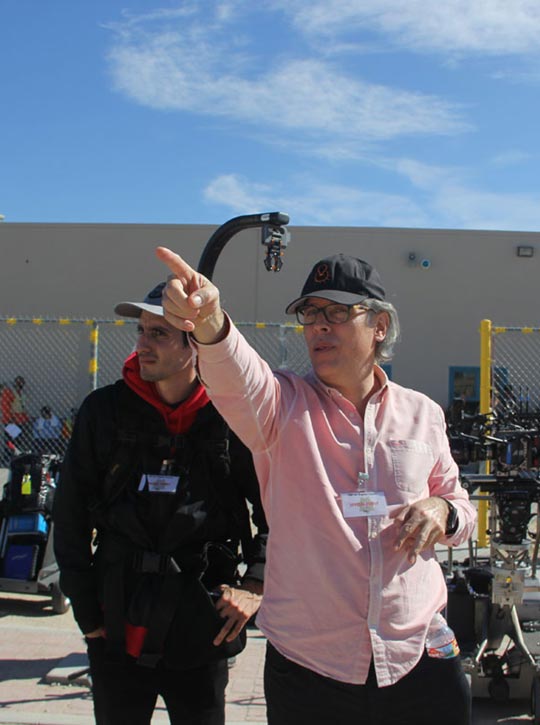 Man pointing and discussing something with a documentary crew member