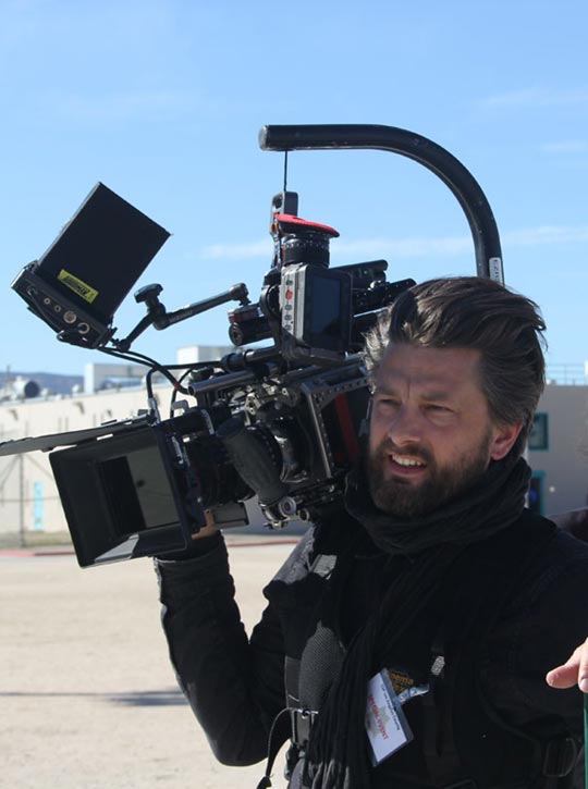 Videocamera man on the set of Step Inside The Circle smiling