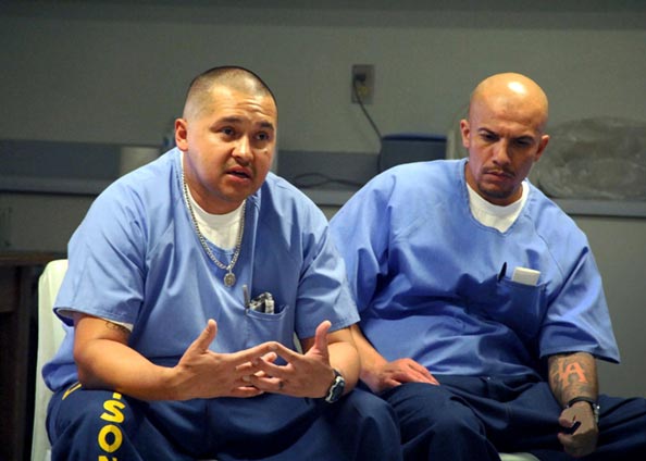 Two incarcerated men sitting down talking