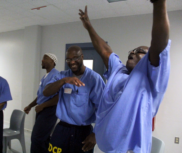 Incarcerated man with hands in the air celebrating