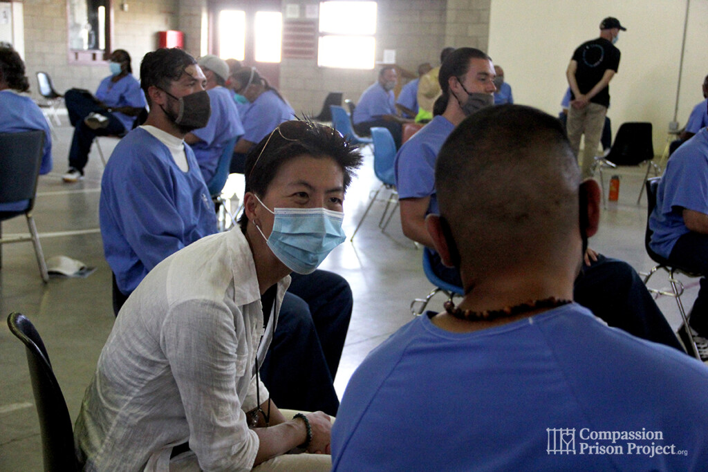 Volunteer engaging in coversation with man living in prison