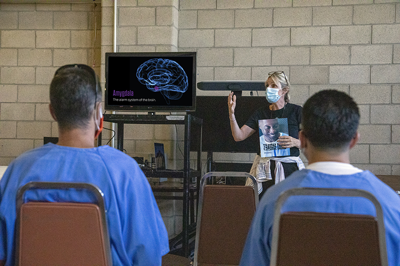 Fritzi in front of men showing them Trauma Talks