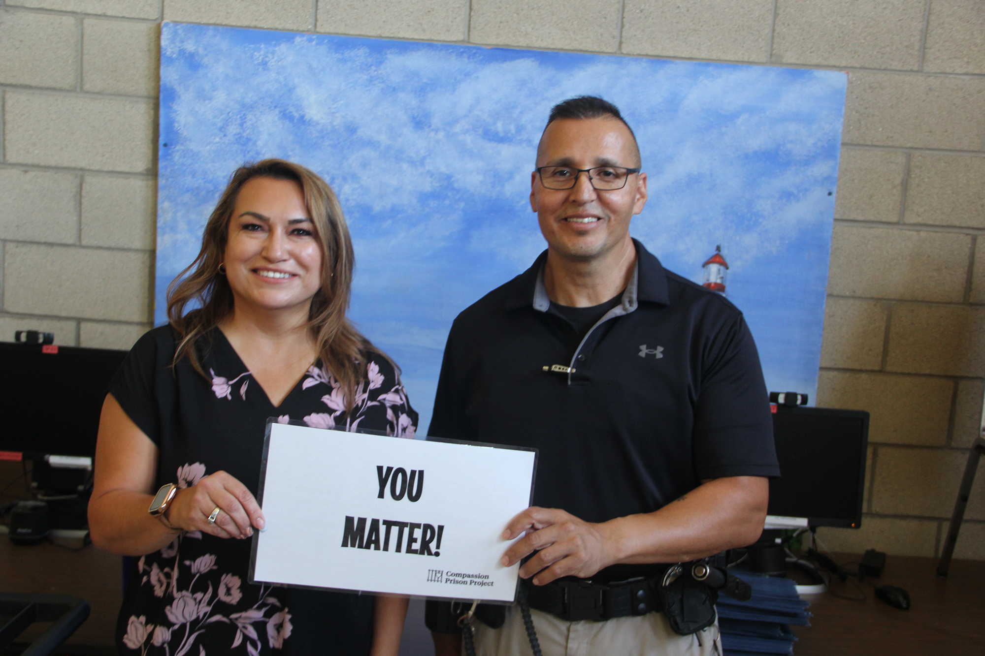 Man and woman holding a "you matter" sign